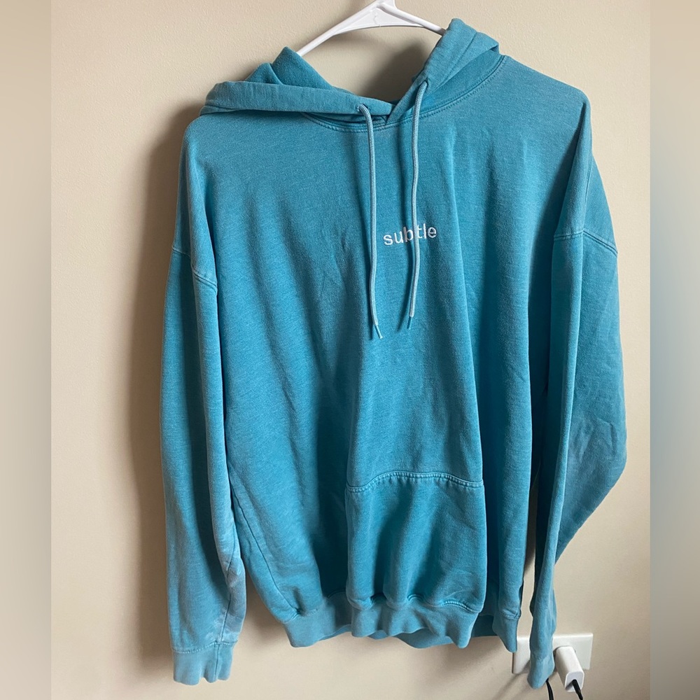 “Subtle” light blue/teal sweatshirt